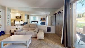 a living room with a couch and a living room with a kitchen at Elkhorn Village Studio 2026 in Sun Valley