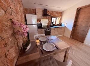 a kitchen with a wooden table and a refrigerator at Évasion au calme in Montauroux