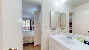 a bathroom with a sink and a mirror and a bed at Elkhorn Village Studio 2026 in Sun Valley