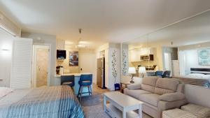 a bedroom with a bed and a living room with a couch at Elkhorn Village Studio 2026 in Sun Valley