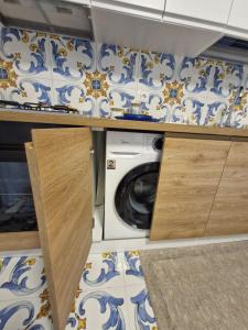 a laundry room with a washer and dryer at Sea View MdG in Marina di Gioiosa Ionica
