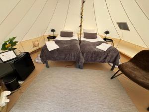 a room with a bed and a tv in a tent at Hotell Briggen i Åhus in Åhus