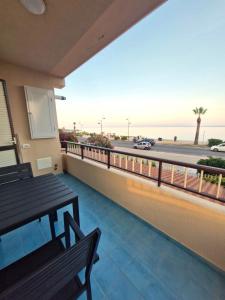 a balcony with a bench and a view of the ocean at Sea View MdG in Marina di Gioiosa Ionica