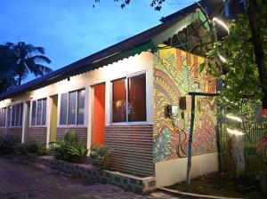 a house with a painting on the side of it at SHANKARDHABA&resort in Guwahati