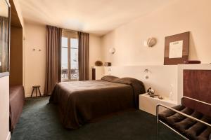 a hotel room with a bed and a window at Hôtel Nude Paris - Color Vision in Paris