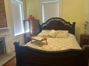 a bedroom with a large bed with a table on it at Catherine's Palace in Vicksburg
