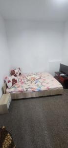 a bed in a room with a bed frame and a bed sidx sidx at D&ATurism in Prăjila