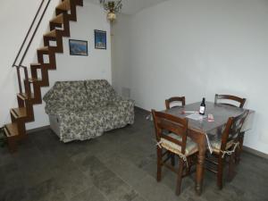 a living room with a table and a couch at Ca' Fontanetta Holiday Home in Caprie +10 photos