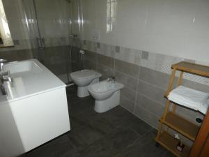 a bathroom with a toilet and a sink at Ca' Fontanetta Holiday Home in Caprie