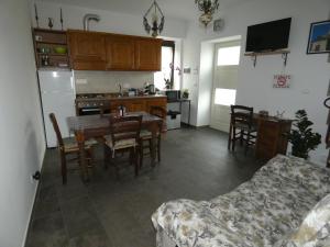 a kitchen and dining room with a table and chairs at Ca' Fontanetta Holiday Home in Caprie