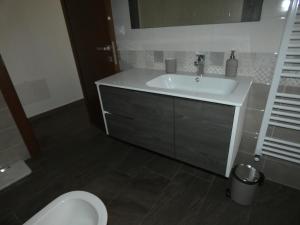 a bathroom with a sink and a toilet at Ca' Fontanetta Holiday Home in Caprie