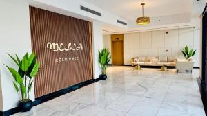 a lobby with couches and a large screen in a building at جناح فاخر بإطلالة على البحيرة وجاكوزي خاص in Al Khobar +12 photos