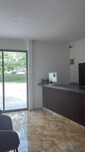 an office with a reception desk and a glass door at Hotel Kleos in Cárdenas
