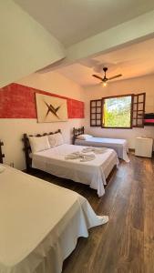 a bedroom with two beds and a window at Pousada sollaris in Serra do Cipo +26 photos