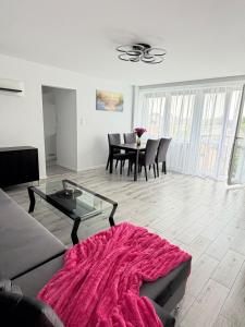 a living room with a couch and a table at Silver II in Świnoujście