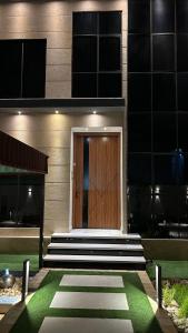 a wooden door on the side of a building at Rawnaq aljabal chalet in Qurayyah +3 photos