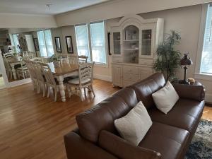 a living room with a leather couch and a table at Pigeon's Roost on Rushmore in Rapid City