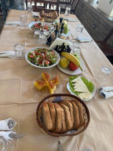 a table with plates of food on a table at Ambra & Arber Hotel in Bogovë