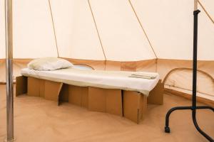 a small bed in a tent in a room at NIBIRU OFFICIAL ACCOMMODATION LUNR Camp in Costinesti