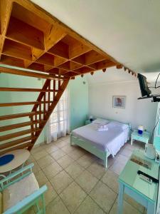a bedroom with a bed and a staircase at Villa Nefeli in Perissa