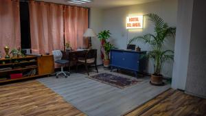 an office with a desk and a table with a chair at Hostal del angel in Mexico City