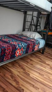 a bunk bed in a room with a wooden floor at Hostal del angel in Mexico City