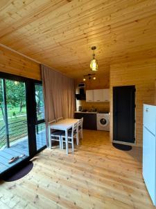 a kitchen and living room with a table and a refrigerator at Dore in Kobuleti in Kobuleti
