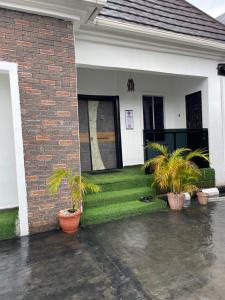a house with plants in the front yard at At Kora Apartment and Shortlets in Asaba