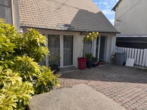 a house with a porch with potted plants on it at Villa Auguste chambres d'hôtes in Quimper