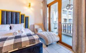 a bedroom with a bed and a chair and a window at Diani Beachfront by Bstan in Diani Beach +36 photos