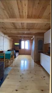 a large room with a wooden ceiling and a kitchen at Nino apartment in Dvabzu
