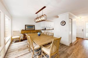 a kitchen and dining room with a wooden table and chairs at Twin Oaks 207 in Hilton Head Island