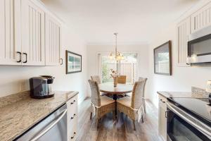 a kitchen with a table and chairs in a room at Twin Oaks 207 in Hilton Head Island