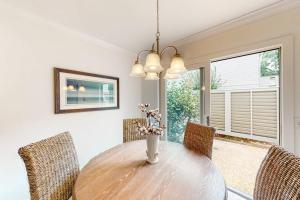 a dining room with a wooden table and chairs at Twin Oaks 207 in Hilton Head Island