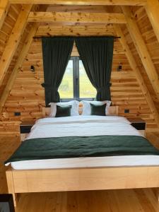 a bedroom with a large bed in a wooden house at V Chalet in Žabljak
