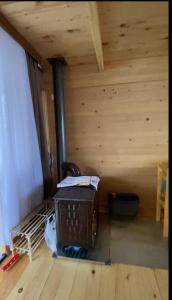 a room with a woodburning stove in a cabin at Nino apartment in Dvabzu