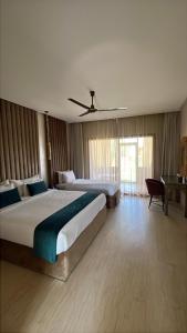 a hotel room with two beds and a window at Hôtel Jardins de lina et lea in Marrakesh +38 photos