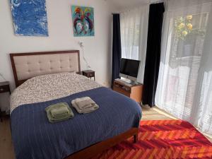 a bedroom with a bed with two towels on it at Villa Auguste chambres d'hôtes in Quimper