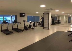 a gym with treadmills and exercise equipment in a building at Flat com parque aquatico in Rio Quente