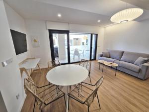 a living room with a table and chairs and a couch at BR Silgar Club in Sanxenxo
