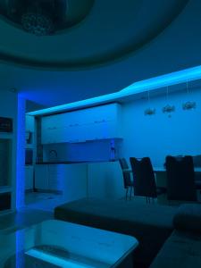 a living room with blue lights on the wall at Duplex in Kosovo Polje +3 photos
