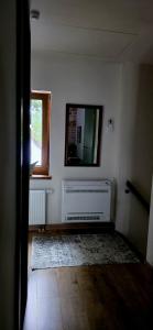 a room with a radiator and a television on the wall at Sosnówka in Kolonowskie