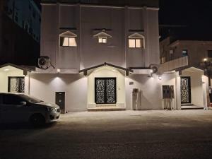 a car parked in front of a building at night at The Italian Studio3 in Dammam