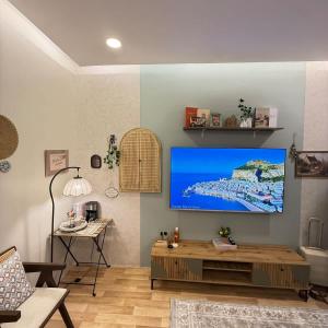 a living room with a flat screen tv on a wall at The Italian Studio3 in Dammam
