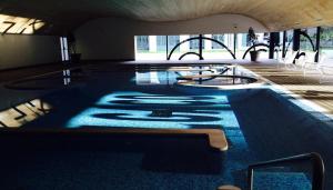 a large swimming pool with a labyrinth in a building at Bungalow Refúgio do Pezo T1 in Melgaço