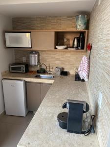 a kitchen with a sink and a counter top at Flat com parque aquatico in Rio Quente