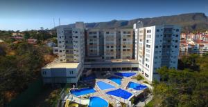 an overhead view of a building with blue umbrellas at Flat com parque aquatico in Rio Quente