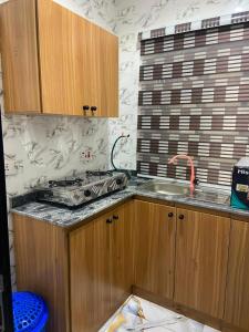 a kitchen with a sink and a counter top at whitestone palace hotel in Eggan
