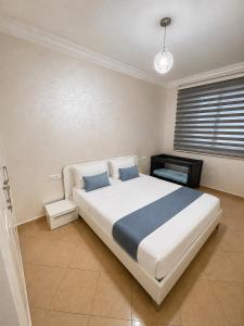 a bedroom with a large bed and a television at Royal Rif Alhoceima Centre in Al Hoceïma