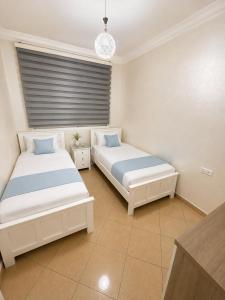 a bedroom with two beds and a window at Royal Rif Alhoceima Centre in Al Hoceïma